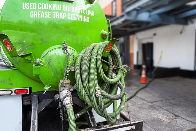 technicians pumping out a commercial grease trap in Elk Grove